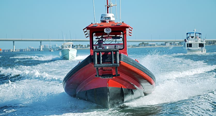A front view of a Towboat cruising down a river