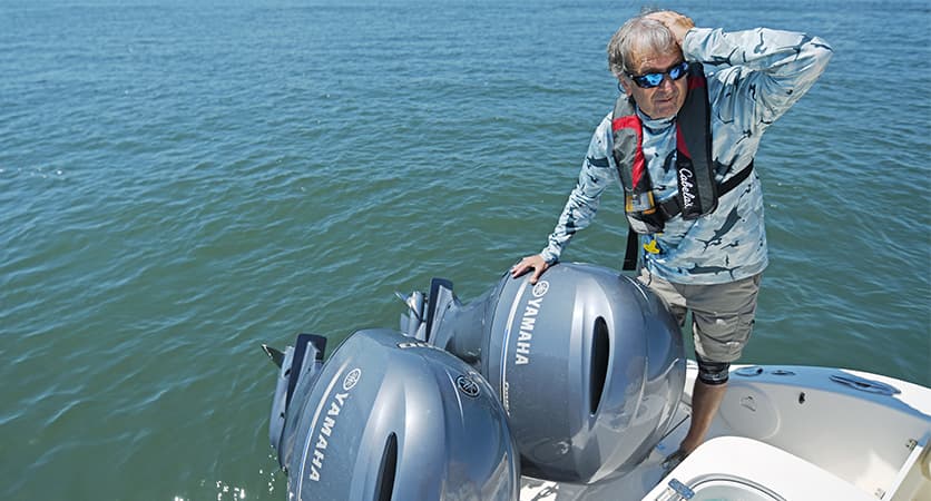 Customer near their boat engines looking frustrated