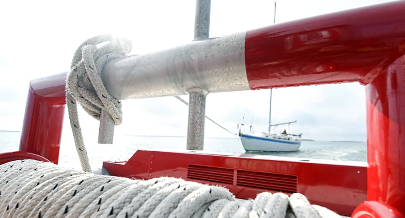 Towboat helping unground customer's boat from a soft sandbar